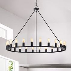 Striking allure and eye-catching, this wagon wheel chandelier is sure to make for an impressive addition to your home decor. This lighting features a metal round wagon wheel design with 24 bright bulbs that provide plenty of illumination in a wide area. Make a statement in your home with this positively posh chandelier. Gracie Oaks Finish: Matte Black | Gracie Oaks Atonvale 24 - Light Unique Wagon Wheel Chandelier black, Metal in Matte Black | 34" H X 48" W X 48" D | Wayfair Black Ring Chandelier, Large Entry Chandelier, Modern Wagon Wheel Chandelier, Entry Chandelier, Chandelier Black, Wheel Chandelier, Chandelier Metal, Ring Chandelier, Wheel Design