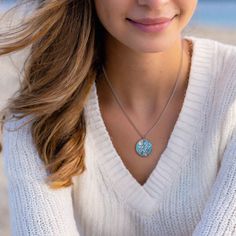 Immerse yourself in a world of playful refinement with our Into the Blue Necklace—a truly lovely adornment that effortlessly captures the mesmerizing essence of the wonders of the seas. This necklace isn't just jewelry; it's a wearable masterpiece, designed to evoke the allure of ocean depths and the enchanting mysteries found beneath the waves. Elevate your style with this captivating piece, a harmonious blend of playfulness and refined elegance. Dive into the world of ocean-inspired fashion an Ocean-inspired Pendant Necklace With Lobster Clasp, Ocean-inspired Sterling Silver Pendant Jewelry, Blue Round Pendant Jewelry For Her, Blue Round Pendant Jewelry Gift For Her, Ocean-inspired Jewelry With Lobster Clasp And Round Pendant, Adjustable Aquamarine Jewelry, Adjustable Aquamarine Bracelet, Adjustable Aquamarine Round Jewelry, Beach Pendant Jewelry With Clavicle Chain