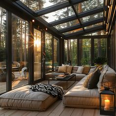 the sun shines through the glass roof in this living room with couches and pillows