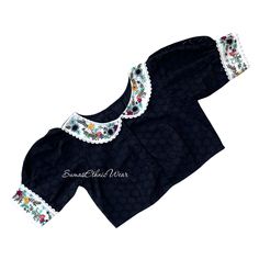 Indulge in traditional yet modern style like this Hakoba Collar embroidered blouse. It has a high Neck on back and Embroidery on sleeves. Item : Blouse Material : Hakoba Cotton Size fits 36/42 ( Margins Included) Colour : Black Sleeve length : 9.5 inches Puff Sleeves Back Neck : High Neck, Front Neck : 6.5 inches - Collar Neck Padding : No Lining : Yes  Blouses are designed in-house from SumasEthnicWear  Care : Hand wash separately | line dry in shade | warm Iron Note: Minor colour differences p Collar Blouse Designs, Collar Neck, Blouse Material, Collar Blouse, Embroidered Blouse, Saree Blouse, Puff Sleeves, Boho Shorts, Womens Clothing Tops