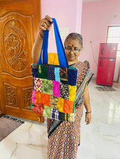 Ever wanted a bag that can carry almost everything that you can carry- this is one such bag. Made completely from tiny pieces of fabric thrown away by tailors, this patchwork tote bag is a perfect mix of style and utility.  It is a 13" x 14" with a 3" base as well. Has a pocket on the inside for you to quickly take out something you might need. The handle is made out of woven cotton. The inside lining is pure cotton. Completely washable, can handle weight upto 4 kgs. Please wash in cold water as it is good for the environment too.  Please note: The images are just a representation of the bag- every bag you see is unique. You can choose the colour of the handle. Rest is a mix of different colours and material. The colours of the patches you receive might not match the patchwork shown in the Multicolor Pouch Box Bag For Daily Use, Multicolor Rectangular Box Bag For Gifts, Rectangular Multicolor Box Bag For Gifts, Multicolor Rectangular Box Bag, Colorful Cotton Bags For Everyday Use, Travel Cotton Bag With Patchwork, Patchwork Tote Bag For Shopping, Everyday Use Patchwork Tote Bag, Shopping Tote Bag With Patchwork