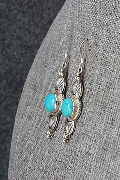 These turquoise and sterling silver earrings were made by Navajo silversmith Michael Calladitto. The back is signed M&R Calladitto and stamped .925.Length: 1 7/8"Width: 1/2"Free shipping on all orders! We ship with USPS and always include tracking. All orders ship within a day of payment.Returns are accepted up to 30 days after you receive your order. Just send us a message. Our shop offers cash back or store credit. The item must be returned in new condition. Artisan Turquoise Concho Earrings, Elegant Concho Earrings For Gift, Elegant Blue Jewelry With Concho Detail, Elegant Blue Concho Jewelry, Turquoise Concho Dangle Jewelry, Sterling Silver Turquoise Concho Jewelry, Blue Sterling Silver Western Jewelry, Blue Western Sterling Silver Jewelry, Western Style Nickel-free Turquoise Earrings