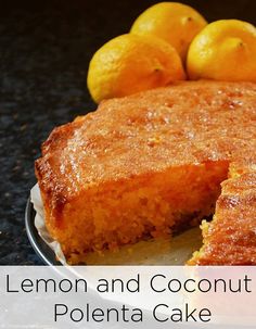 a lemon and coconut polenta cake on a plate with some lemons in the background