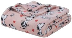 a pink blanket with snoopy dogs and hearts is folded on top of each other