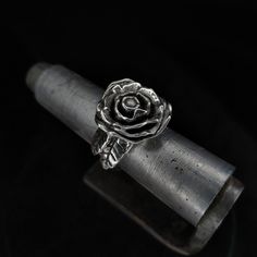 A beautiful sterling silver polished metal rose ring, blossoming on a finger is sure to grabb attention anywhere it is seen. Grab this pretty artefact for your goth girlfriend, mother or anyone who is into flowers and likes 3d metal sculptures.  Cast out of sterling silver as a single piece of metal, this ring has no joints or soldered parts, it is strong and durable.  Any finger size is available, as well as all sorts of customizations, contact me via Etsy messages for any further information. Silver Flower Ring With Roses For Gift, Silver Flower Ring With Rose Design, Silver Rose Design Ring, Silver Ring With Rose Design, Silver Rose Design Jewelry For Promise Ring, Silver Flower-shaped Rings With Rose Design, Silver Flower Ring With Roses For Wedding, Sterling Silver Rose Flower Ring With Rose Design, Silver Wedding Ring With Roses