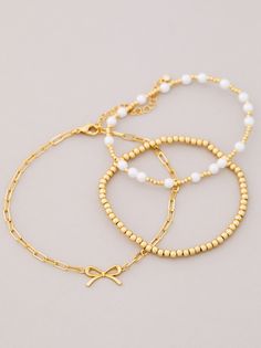 The 3 Pack Bow Gold Bracelet Set, designed for plus-sized women to fit comfortably, features beaded and pearl accents, complemented by 18k gold dipping to ensure durability and prevent tarnishing. Girly Christmas Gifts, Girly Christmas, Skirt And Top Dress, Gold Bracelet Set, Pearl Bow, Pearls Diy, Bow Bracelet, Gold Dipped, Romper With Skirt