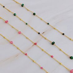 Elevate your everyday look with our Dainty Precious Stone Bead Necklace. The delicate chain showcases varying sizes of beautifully placed stone balls, offering a touch of daintiness to any outfit. Perfect for layering or wearing on its own, this versatile necklace will effortlessly take you from casual to dressy occasions. 18k gold plated brass, natural stone beads Lead and Nickel free Designed in US, crafted in China Stone Bead Necklace, Green Stone Necklace, Natural Stone Beads, Stone Beaded Necklace, Hair Setting, Moissanite Jewelry, Delicate Chain, Green Necklace, Pink Stone