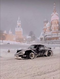 a black and white car parked in the snow