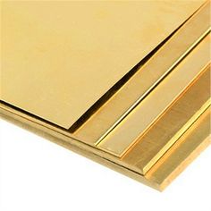 three gold colored metal sheets stacked on top of each other