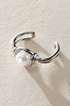 Add the coolest touch to your earring collection with this effortlessly edgy cuff featured in a pearl-adorned design with knot-inspired bezel detailing for an added special touch. | Last Text Ear Cuff by Free People in Silver Elegant Round Metal Ear Cuff, Trendy Adjustable Pearl Ring, Elegant Nickel-free Metal Ear Cuff, Adjustable Metal Elegant Ear Cuff, Elegant Adjustable Metal Ear Cuff, Trendy Adjustable Pearl Drop Jewelry, Chic Silver Ear Cuff For Gift, Free People Earrings, Gold Ear Cuff