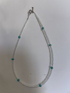 This necklace is a simple teal and white necklace. The white are the smaller beads and the teal beads are a little bigger. These are $7. These can be customized to any length or design. White Bohemian Turquoise Necklace As Gift, Bohemian White Turquoise Necklace As Gift, White Beaded Necklace With Round Beads, Adjustable Single Strand White Beads, Handmade Adjustable White Turquoise Necklace, White Bohemian Beaded Necklaces With Letter Beads, Bohemian White Beaded Necklaces With Letter Beads, White Tiny Beaded Necklaces For Jewelry Making, White Single Strand Beaded Necklace As Gift