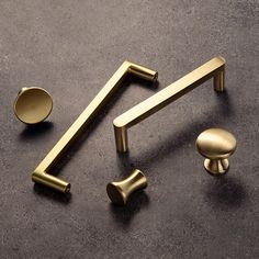 brass handles and knobs on a black surface