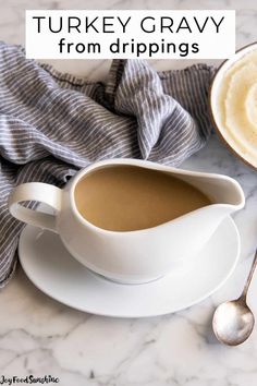 a cup of turkey gravy on a saucer