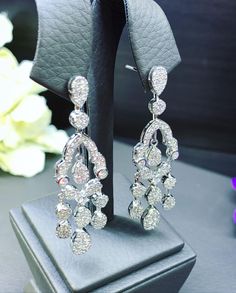 HANDCRAFTED TO PERFECTION! SPECIAL AND LOVELY FLORAL DESIGN, ILLUSION SETTING (APPEARS TO BE LIKE A 0.5-1.0 CARAT BRILLIANT PEAR Diamonds). With over 128 pieces of UNTREATED AND GENUINE F/VS QUALITY SPARKLING DIAMONDS! Perfect for every event! SET IN 18K SOLID WHITE GOLD HANDCRAFTED, CHANDELIER EARRINGS! SUGGESTED RETAIL VALUE: $11,000 DIAMONDS: 254 ROUND BRILLIANT, FULL CUT with excellent firing diamonds, weighting at 3.50 carats. ALL NATURAL, UNTREATED DIAMONDS. ALL DIAMONDS HAVE NO VISIBLE IN Anniversary Diamond Chandelier Earrings With Brilliant Cut, Diamond Chandelier Earrings With Brilliant Cut For Anniversary, Formal Diamond White Chandelier Earrings With Brilliant Cut, White Gold Drop Chandelier Earrings For Evening, Diamond White Brilliant Cut Chandelier Earrings For Anniversary, Diamond White Chandelier Earrings With Brilliant Cut For Anniversary, Dazzling Diamond White Dangle Chandelier Earrings, Luxury Diamond White Chandelier Earrings With Elegant Design, Dazzling White Gold Brilliant Cut Chandelier Earrings