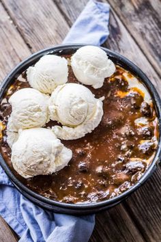 three scoops of ice cream sit on top of a stew in a skillet