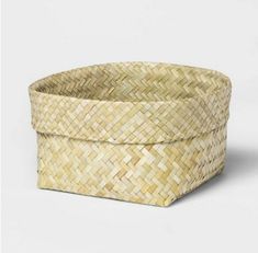 a woven basket is shown on a white background, with the lid open to show it's interior