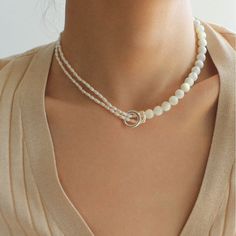 This stunning necklace features an elegant blend of 8mm natural white mother-of-pearl and delicate millet pearls, creating a chic half-and-half design that is both eye-catching and fashionable. With its sophisticated yet modern aesthetic, this piece brings an air of elegance and grace to any outfit. Whether paired with a dress, blazer, or knitwear, it adds a soft and refined touch, making it the perfect accessory for a variety of styles. Metal: Recycled Sterling Silver Plated On Brass Material: Freshwater Pearls/ 8mm White Mother-of-pearl Length: 330-390mm/33-39cm Elegant Polished Bead Necklaces, Elegant Mother Of Pearl Necklace, White Mother Of Pearl Shell Necklace With Pearl Pendant, Elegant Pearl White Mother Of Pearl Beaded Necklaces, Chic Pearl White Necklace With Pearl Charm, Elegant Pearl Chain Beaded Necklaces, Elegant Cream Necklace With Pearl Charm, Elegant Cream Necklaces With Pearl Charm, Delicate White Mother Of Pearl Necklace