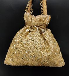 sparkling gold sequin & bead handbag woman designer drawstring purse bag | embellish golden silk fabric embroider evening bag for womanPackage Contents: 1Size: 8" x 8.5"Designed with the heart, this beautiful Potli or batawa bag are eye catchy and made of premium material.Key Features:Art work. This potli is good match with both Indian and western outfits and are superb for wedding and festive parties.This would be best complement to your designer saree, lenhga or any other kind of dress.Thi Festive Embellished Potli Bag As Gift, Gold Sequined Bags For Party, Gold Evening Bag With Zari Work, Luxury Gold Evening Bag With Handwork, Gold Sequined Party Bag, Gold Sequin Party Bag, Gold Party Bags With Sequins, Evening Gold Bag With Zari Work, Gold Beaded Pouch Potli Bag