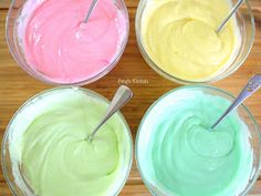 four bowls filled with different colored cake batter