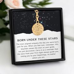 a necklace with an image of a star in the sky on it that says, born under these stars