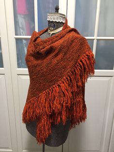 This is a beautiful and rare Hand loomed 70% wool shawl wrap. Lovely generous size. Measures 76 inches along the interior edge and 38 inches long at its longest point. Made by the much sought after Au Terroir out  of Ste. Madeleine Quebec Canada. Really timeless fashion piece to add to any style or wardrobe. I have also the matching wrap skirt and poncho both sold separately in the shoppe. Nice autumn / fall colours. Brown Wool Shawl Scarf, Fall Handwoven Alpaca Shawl, Handwoven One-size Shawl For Fall, Hand Knitted Shawl Wrap For Fall, Handwoven Shawl For Fall, One Size, Brown Wool Shawl One Size, Bohemian Handwoven Wool Poncho, One Size Brown Wool Shawl, Brown One-size Wool Shawl