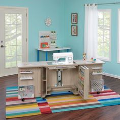 a child's room with a sewing machine and craft table on the rug in front of it