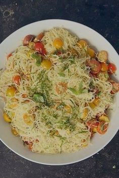 a white bowl filled with pasta and vegetables