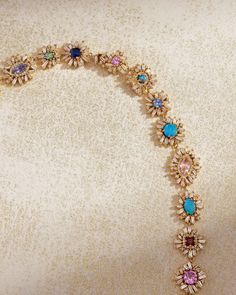 Embrace the enchanting beauty of this One of a Kind Opal and Sapphire Flower Riviere Necklace. Each meticulously crafted flower showcases a radiant opal doublet or a vibrant sapphire, framed by delicate petals of champagne diamonds. Set in 18-karat yellow gold, this necklace is a harmonious blend of colors and textures, capturing the essence of nature's beauty in a timeless design. This piece is an exquisite addition to any fine jewelry collection, celebrating the unique and the extraordinary. D Formal Multi-stone Flower-shaped Jewelry, Luxury Gemstone Jewelry In Flower Shape, Elegant Multicolor Flower-shaped Jewelry, Multicolor Multi-stone Flower Jewelry, Multicolor Flower-shaped Multi-stone Jewelry, Elegant Multicolor Flower Shaped Necklace, Elegant Flower Shaped Jewelry With Gemstone Accents, Elegant Flower-shaped Jewelry With Gemstone Accents, Champagne Diamond Necklace