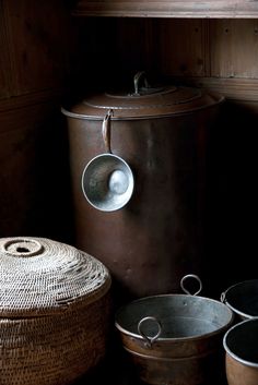 several buckets and baskets are sitting on the floor