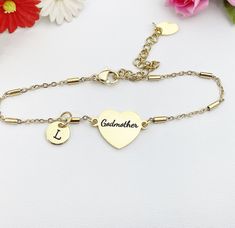 "This is an engraving Godmother on stainless steel with hand stamp Initial charm on stainless-steel bracelet. ♥ You will receive 1 bracelet  HOW TO ORDER 1) Select the quantity. 2) Select the initial and finish. 3) Add to cart. DESCRIPTION ♥ Handmade 304 Stainless Steel Bracelet with Oval Charms Extender and Lobster Claw Clasps, Tube, Gold Color, Size: about 6-1/4 inch (16cm) long (excluding chain extender), link: 0.20x0.08 inch(5x2mm), ring: 0.16x0.02 inch(4x0.5mm), extender chain: 2.40 inch(61mm) long. ♥ Initial Charm, Stainless-Steel, Gold Color, Size: about 8-10mm or about 3/8\" ♥ God mother, engraving on 201 Stainless Steel, Manual Polishing, Heart, Gold Color, Size: about 20mm wide, 14mm long, 1.5mm thick, PLEASE READ: ♥ We are happy to help with any situation so please reach out wit Heart-shaped Stainless Steel Bracelet For Mother's Day, Personalized Stainless Steel Heart Bracelet For Mother's Day, Gold Stainless Steel Name Bracelet For Mother's Day, Mother's Day Engraved Stainless Steel Name Bracelet, Mother's Day Gift Stainless Steel Name Bracelet, Mother's Day Stainless Steel Name Bracelet, Hand Stamped Name Bracelet For Mother's Day Anniversary, Engraved Stainless Steel Name Bracelet For Valentine's Day, Valentine's Day Engraved Name Bracelet In Stainless Steel