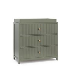 a green dresser with three drawers and two brass knobs on the top, in front of a white background