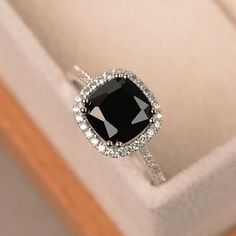 a black and white diamond ring in a box