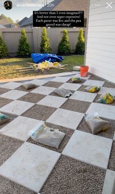 a large checkerboard pattern on the ground in front of a house that is being remodeled