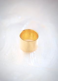 A statement gold wide band ring made from gold plated sterling silver. This gorgeous gold ring packs a punch. A modern staple for your collection.✦ DETAILS ✦✧ Name: Kahekili - (KAH heh KEE lee) - the thunder.✧ You will receive 1 ring 14mm wide. 9mm Band Sold Separately.✧ Available in whole sizes 5-11. PLEASE ORDER ONE SIZE UP; Wide rings fit tighter.✧ Gold Vermeil - gold plated sterling silver.✧ All Ke Aloha Jewelry pieces come packaged thoughtfully, beautifully, and ready for gift giving. Photo Modern Gold Wide Band Ring As Gift, Gold Thick Band Ring As Gift, Gold Wide Band Ring As Gift, Gift Gold Thick Band Ring, Gold Plated Wide Band Ring As Gift, Gold Plated Wide Band Ring For Gift, Gold-plated Wide Band Ring As Gift, Gold Cuff Ring, Thick Gold Ring