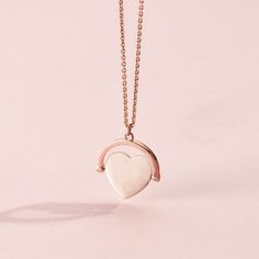 This gorgeous Heart Spinner Necklace is made from 18ct Rose Gold plated Sterling Silver. The design features a spinning heart pendant suspended from one of our classic trace chains.  The Spinning Necklace is reminiscent of traditional spinning necklaces with a modern luxe twist. Each necklace is handcrafted in our Brighton workshop from solid sterling silver then plated in 18ct Rose gold plate. Pendant measures approx 17. 2mm x 18. 3mm. Comes suspended on 18" chain. 18ct Rose Gold plated Sterlin Rose Gold Heart Pendant Necklace Fine Jewelry, Heart-shaped Rose Gold Charm Necklace With Chain, Rose Gold Heart Charm Fine Necklace, Fine Jewelry Rose Gold Necklace With Heart Charm, Rose Gold Fine Jewelry Necklaces With Heart Charm, Minimalist Rose Gold Heart Cut Jewelry, Rose Gold Charm Necklace With Heart Pendant, Rose Gold Heart Pendant Charm Necklace With Delicate Chain, Rose Gold Pendant Heart Necklace For Valentine's Day