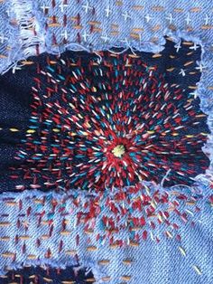 an old pair of jeans with colorful thread sprinkles