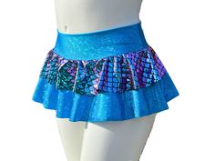 "Stand out in the music festival crowd in this Made-To-Order Holographic Mermaid Rave Skirt! Not only is it beautiful, but the skirt is made from quality performance spandex that is comfortable and will last. The waistband is a double layer of spandex and the skirt is a full circle. The base skirt is hemmed. Feel free to twirl, dance, and sit comfortably in this skirt.  Size Chart (by waist measurement) **Please measure where you will wear the waistband to insure the proper fit** XS 24-26\" S 27-29\" M 30-33\" L 34-36\" XL 37-39\" 2X 40-42\" Lengths are measured from the top of the waistband to the bottom of the base skirt. The waistband is approximately 3\" tall. Micro 10\" Mini 12\"  Sport 15\"  Optional attached shorts will be made out of the same fabric as the main base skirt and will Mermaid Short Skirt, Fitted Mini Skirt With Built-in Shorts For Cheerleading, Cheerleading Mini Skirt Bottoms With Built-in Shorts, Cheerleading Mini Skirt With Built-in Shorts, Cheerleading Skirt With Built-in Shorts, Disco Style Stretchy Shorts, Disco Stretch Shorts, Disco Style Stretch Shorts, Summer Rave Shorts For Club