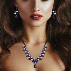 A majestic display of mystical color.Draw back the curtain on elegance to discover an alluring treasure that steals the show.Rich, midnight-black rhodium provides the perfect setting for twilight purple and violet crystals that are lavished with luminous simulated pearls.Enchanting matched set creates a look of sophisticated luxury.Sensational worn together, separately or paired with other favorites for a one-of-a-kind, personal statement of style. Luxury Crystal Jewelry Sets For Party, Purple Party Jewelry, Glamorous Purple Jewelry For Evening, Luxury Purple Jewelry For Party, Purple Luxury Jewelry For Party, Elegant Purple Necklace For Party, Elegant Purple Jewelry Sets For Formal Occasions, Elegant Jewelry Sets With Sparkling Stones For Evening, Elegant Purple Jewelry For Evening