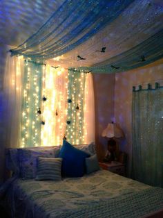 a bedroom decorated with fairy lights and curtains