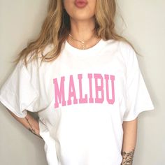 Malibu Trendy Shirt  YOUR SIZE NOT AVAILABLE? Send us a message and we will see what we can do! ::INFO:: * 100% cotton * Graphic is a high-quality screen printed to be durable and long-lasting! * Wash and dry normally (cool settings or air dry for best results) ::SIZING:: * Sizing is unisex so runs like mens, however not overly large * Most women find their normal size works, since they are meant to fit a bit loose. * For best sizing, measure your favorite fitting t-shirt/hoodie/sweatshirt based Oversized White Shirt With Text Print, Trendy Short Sleeve College Shirt, Trendy Short Sleeve Shirt For College, Casual White Letter Print Shirt, Casual White Shirt With Letter Print, White Shirt With Funny Text For Streetwear, Oversized Collegiate Style Tops With Text Print, Oversized College Style Tops With Text Print, Pink Graphic Print Shirt For College