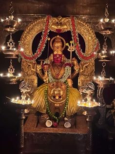 the statue is surrounded by candles and other decorations