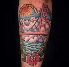 a man with a tattoo on his arm has a rose and the golden gate bridge