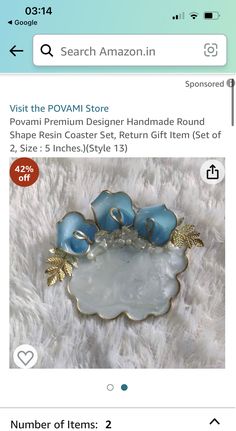 a blue and gold brooch sitting on top of a white furnishing floor