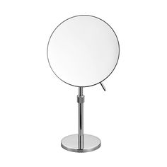 a round mirror sitting on top of a metal stand