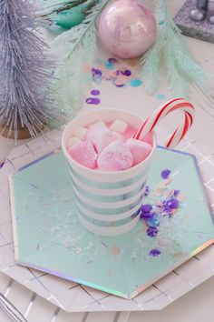 a cup filled with candy on top of a table