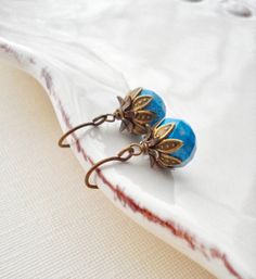 Turquoise Drop Earrings In Antique Brass. Dangle Earrings. These beautiful earrings are made from howlite turquoise faceted rondelle beads 10mm, hand antiqued brass ear wires and antique brass findings.  The length of these earrings is about 0.75". Check out my store to see more of my creations http://www.etsy.com/shop/anechkasjewelry Thank you for looking! Blue Teardrop Brass Earrings, Elegant Turquoise Earrings With Lever Back, Vintage Turquoise Earrings With Round Beads, Nickel-free Turquoise Drop Flower Earrings, Turquoise Teardrop Flower Earrings For Gift, Light Blue Crystal Drop Earrings For Gift, Light Blue Crystal Earrings For Gift, Turquoise Brass Drop Earrings, Turquoise Brass Earrings As Gift