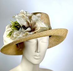 This Kentucky Derby ladies hat with medium size turn up brim. Very neutral. It is the perfect dressy casual hat! Medium tan or golden wheat, a great color and very stylish! It is hand woven straw and shaped on a vintage wooden hat block. Beige dupioni silk ribbon trims the band and sash around the crown. Further adorned with a handmade flower with leaves.. The brim is wired for stability and sustainability. The hat will fit a 22 to 23 1/2 head size. Inside band has an enclosed ribbon for adjustm 20’s Style, Flower With Leaves, Handmade Hats, Flapper Hat, Hat Blocks, Golden Wheat, British Women, Rain Hat, Wedding Hat