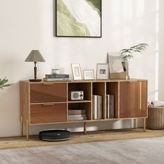 a living room with a book shelf and pictures on the wall next to a rug