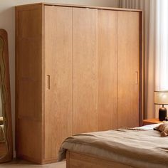 a bedroom scene with focus on the armoire and bed