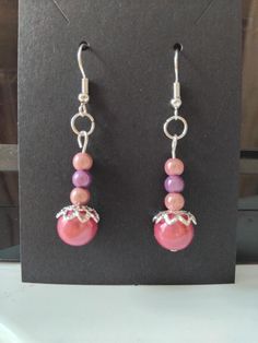 Beautiful large and small miracle beads in deep pink, pink and lilac. A silver bead cap sits on the large miracle bead which is so pretty Elegant Pink Beaded Earrings For Gift, Purple Dangle Beaded Earrings With Spacer Beads, Pink Beaded Dangle Earrings With Bead Caps, Pink Dangle Beaded Earrings With Bead Caps, Colorful Beads Pearl Earrings, Pink Beaded Earrings With Bead Caps, Pink Beaded Earrings With Bead Caps As Gift, Handmade Pink Drop Pearl Earrings, Handmade Pink Pearl Drop Earrings